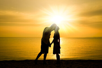 A happy couple by the sea on nature in travel silhouette