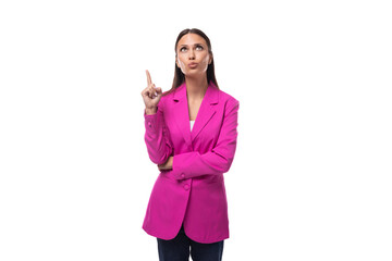 Wall Mural - young smart office worker woman with black hair dressed in a pink jacket stands thoughtfully