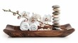 © BackgroundHolic - Clean towel rolls, fresh orchid flowers and stacking zen pebbles served in a wooden tray isolated on whitebackground, for cosmetic, spa, and hot bath relaxation.
