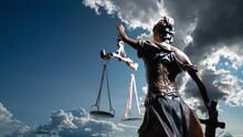 The Statue Of Justice Turns Against The Backdrop Of Clouds Moving Across The Blue Sky. Time Lapse 4k.