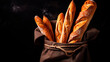 Crispy baguettes in packaging on a dark background, side view with copy space. Fresh bread, pastries with a crispy crust