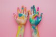 Child hands painted in colorful paints