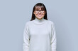 © Valerii Honcharuk - Middle-aged beautiful smiling woman in white sweater on gray studio background