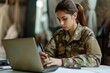© Jorge Ferreiro - young army soldier using laptop typing