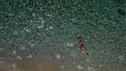 Wall Mural - girl swims in the Mediterranean Sea. turkey beach