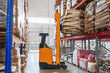 Forklift in a food warehouse loading goods onto a rack, warehouse logistics