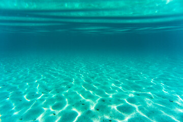 Wall Mural - Beneath surface sand sun blue sky. High quality photo