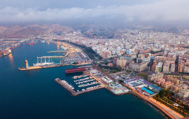 Wall Mural - Evening panoramic view of Mediterranean coastal city of Almeria with harbor, Spain