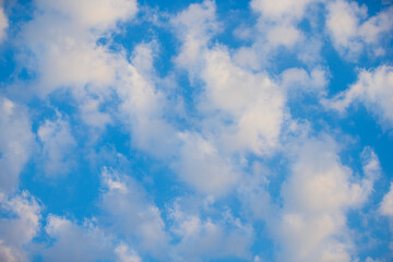 Wall Mural - Sun rays through clouds in the blue sky. Nature background. Selective focus.