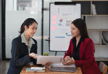 Wall Mural - Young beautiful Asian businesswomen working together in the modern office room.