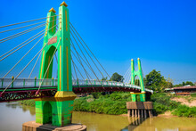 Green Suspension Bridge Across Nan River At Chum Saeng District