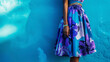 A bold midi skirt covered in oversized blooms in shades of blue and purple adding a pop of color to a monochromatic outfit.