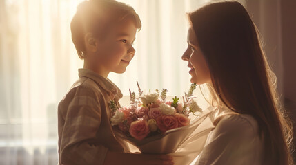 Boy gives flowers to mom