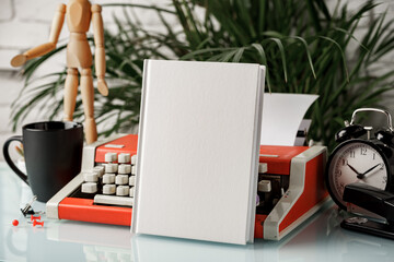 Sticker - Hardcover book and vintage typewriter on white desk