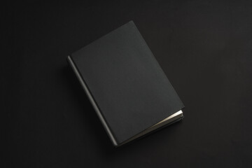 Sticker - Black hardcover book or notepad mock up on black background