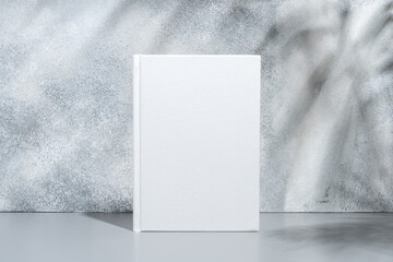 Poster - White blank book with hard cover on gray background with shadows