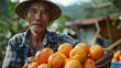 Elderly farmer with freshly harvested oranges