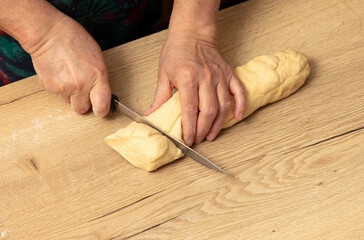 Sticker - A woman cuts dough with a knife