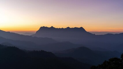 Wall Mural - Morning sunrise behind the majestic view of Doi Luang Chiang Dao in Chiang Mai, Thailand with beautiful colors in the sky