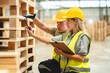 © chokniti - Engineer team standing walking in warehouse examining hardwood material for wood furniture production, Worker check stock, Technician man and woman working on quality control in lumber pallet factory
