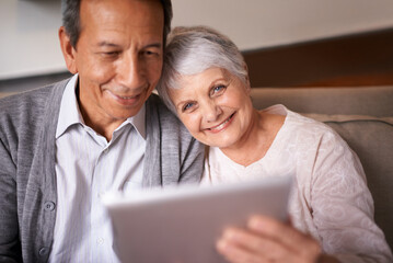 Senior, couple and portrait with tablet on sofa for online bingo, crossword puzzle and internet games with smile. Elderly, man and woman with face and happiness with technology for web news in home