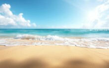 A Sandy Beach With Waves Gently Rolling In Towards The Shore Under A Clear Blue Sky On A Sunny Day