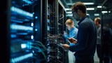 Fototapeta Zwierzęta - Network engineers maintaining servers in a data center, showcasing teamwork, technology, and connectivity.