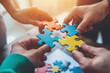 Hands join puzzle pieces,  putting the jigsaws team together, business concept