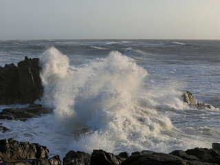 Wall Mural - Small cape being hit by strong stormy sea waves