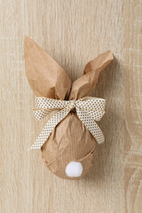 Sticker - Chocolate egg in a wrapper on a wooden background