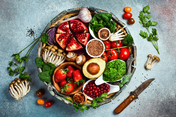 Wall Mural - A set of vegetables, fruits, berries and nuts, mushrooms and superfoods in a wooden round box. Top view.