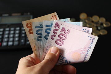 man counting Turkish money with his hand. Turkish lira banknotes. The paper currency of Turkey. Current Turkish liras are issued by The Central Bank of the Republic of Turkey. 