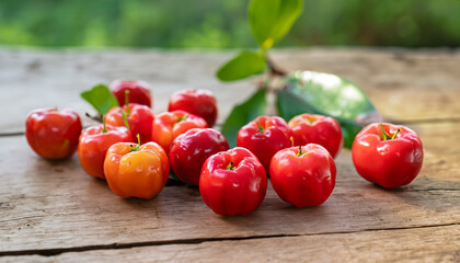Wall Mural - Wild acerola cherries on wooden table in the farm garden