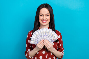 Sticker - Photo portrait of pretty female hold dollars money fan dressed stylish dotted red outfit isolated on blue color background