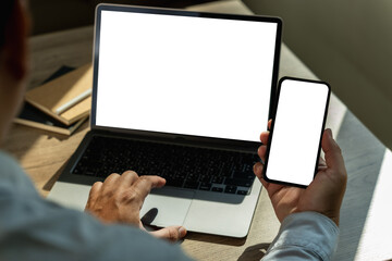 Poster - man with laptop computer at office desk with blank screen in office online shoulder closeup