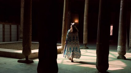 Wall Mural - Woman in the Hall of wooden columns in Juma Mosque in Khiva