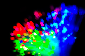 Wall Mural - Close up of blurred light fiber optics for communication technology network