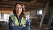 © suteeda - female construction site manager Wear a life jacket and helmet. They laughed happily as they looked at the faces of a group of workers at the construction site.