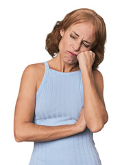 Redhead mid-aged Caucasian woman in studio who feels sad and pensive, looking at copy space.