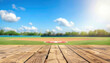 Empty wooden table with blurred baseball field background. Table top product display showcase stage. Image ready for montage your text or product. 