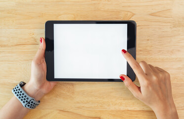 Sticker - Hands holding digital tablet with mockup of blank screen on desk in office room.