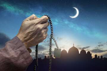 Poster - Muslim man with prayer beads raised her hands and prayed to Allah