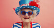Eccentric patriotic grandma celebrating fourth of july, wearing independence day colors and uncle sam hat with ribbons and stars