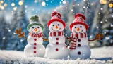 Fototapeta Tęcza - three cute snowmen in a christmas landscape winter background