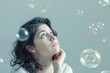 © Hunman - Thinking woman with many ideas in empty bubble on grey background looking up.
