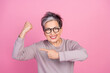 Photo of funny strong retired woman raise arm show strength biceps muscles isolated on pink color background