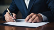 © Pakhnyushchyy - Businessman use elegant pen to signing contract in modern office. The entrepreneur employs a pen to create a notation on the booking schedule.