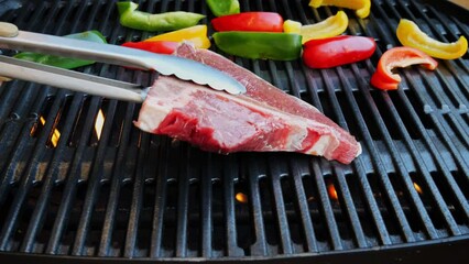 Sticker - T- bone steak put on cast iron grill barbecue. Slow motion