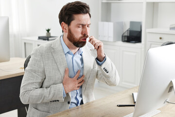 Sticker - Sick man with tissue coughing at workplace in office