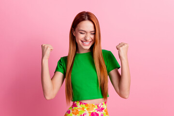 Portrait of satisfied girl with ginger hair wear stylish top clenching fist say yes win gambling isolated on pink color background